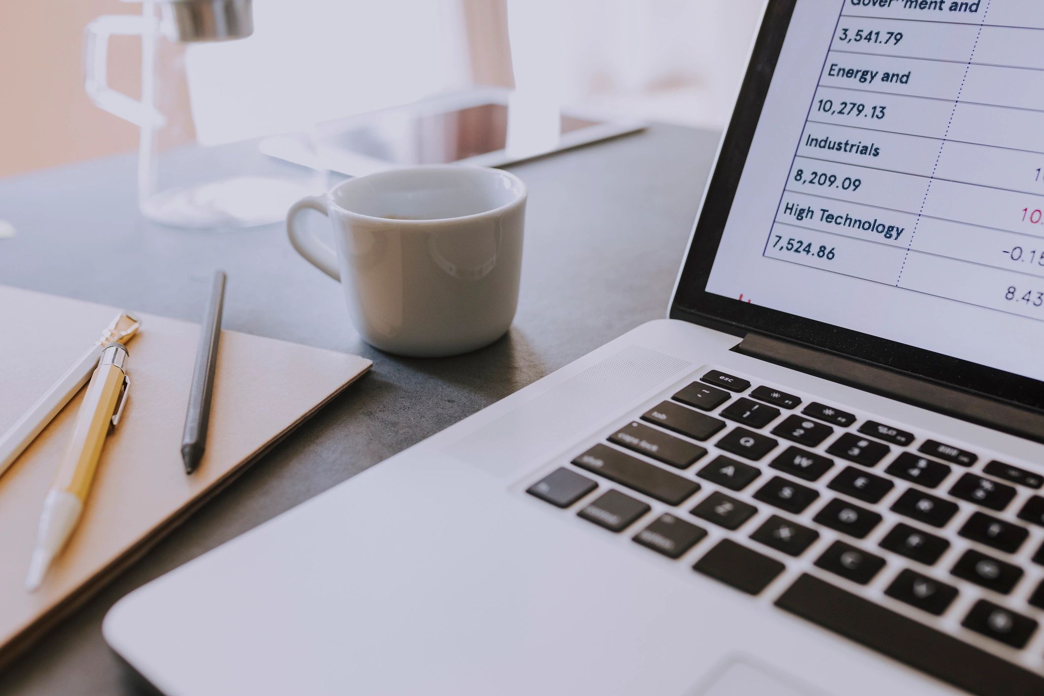 Laptop and paperwork on a desk for bookkeeping work