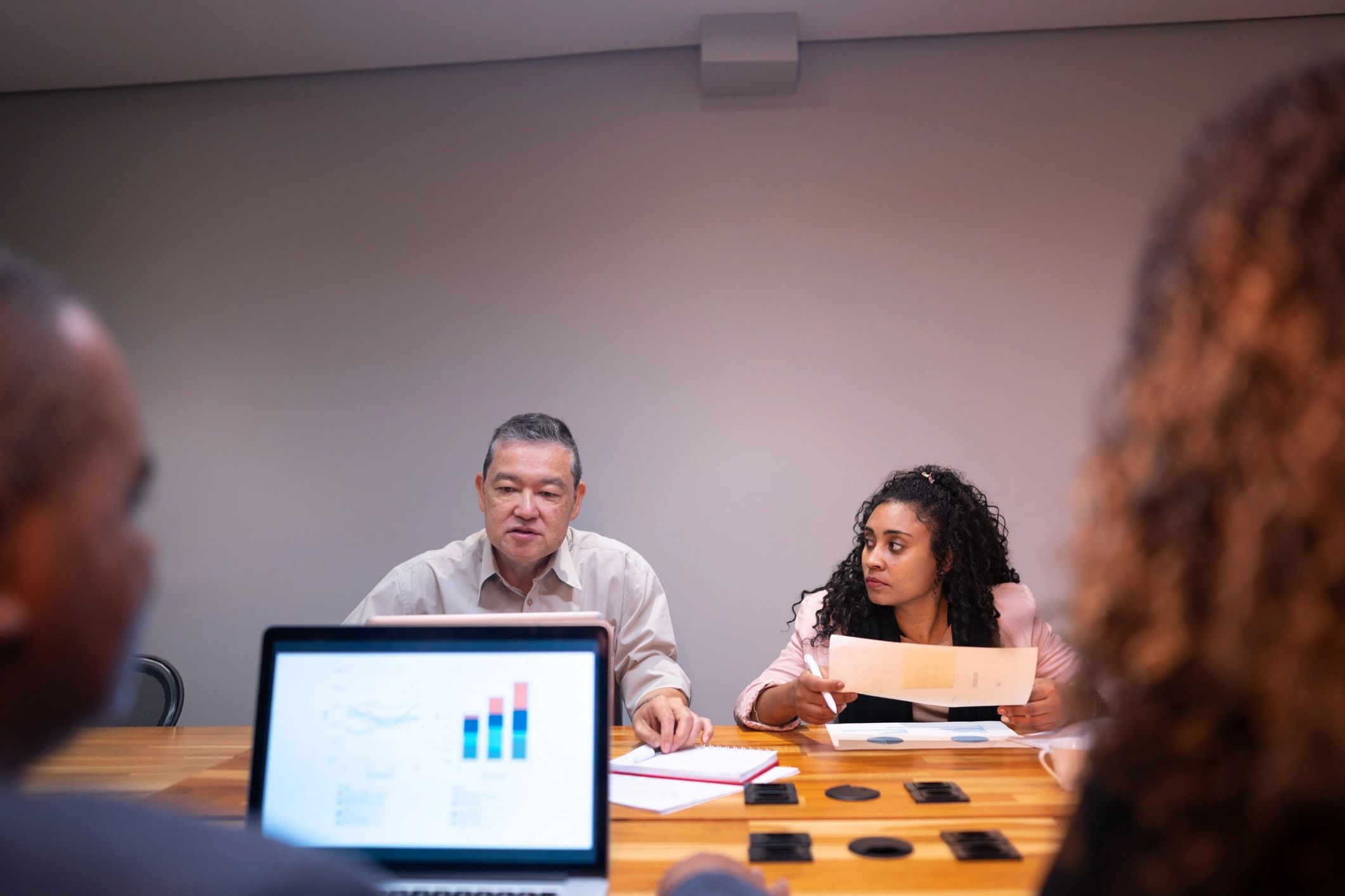 Two coworkers talking during an office meeting