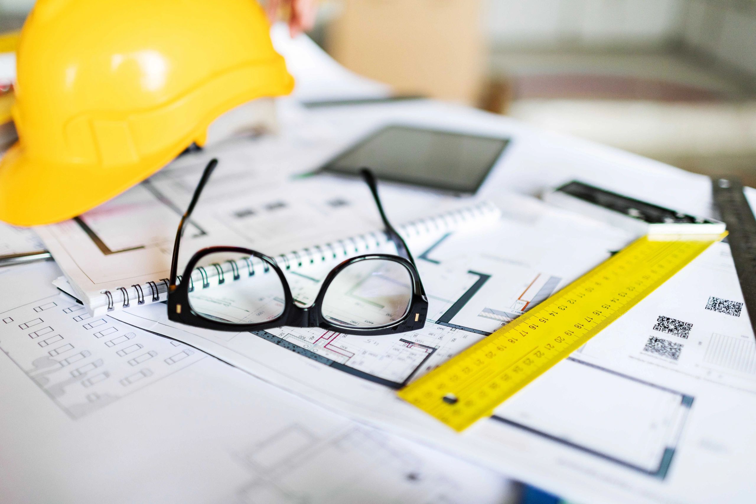 Construction blueprints and tools on a table