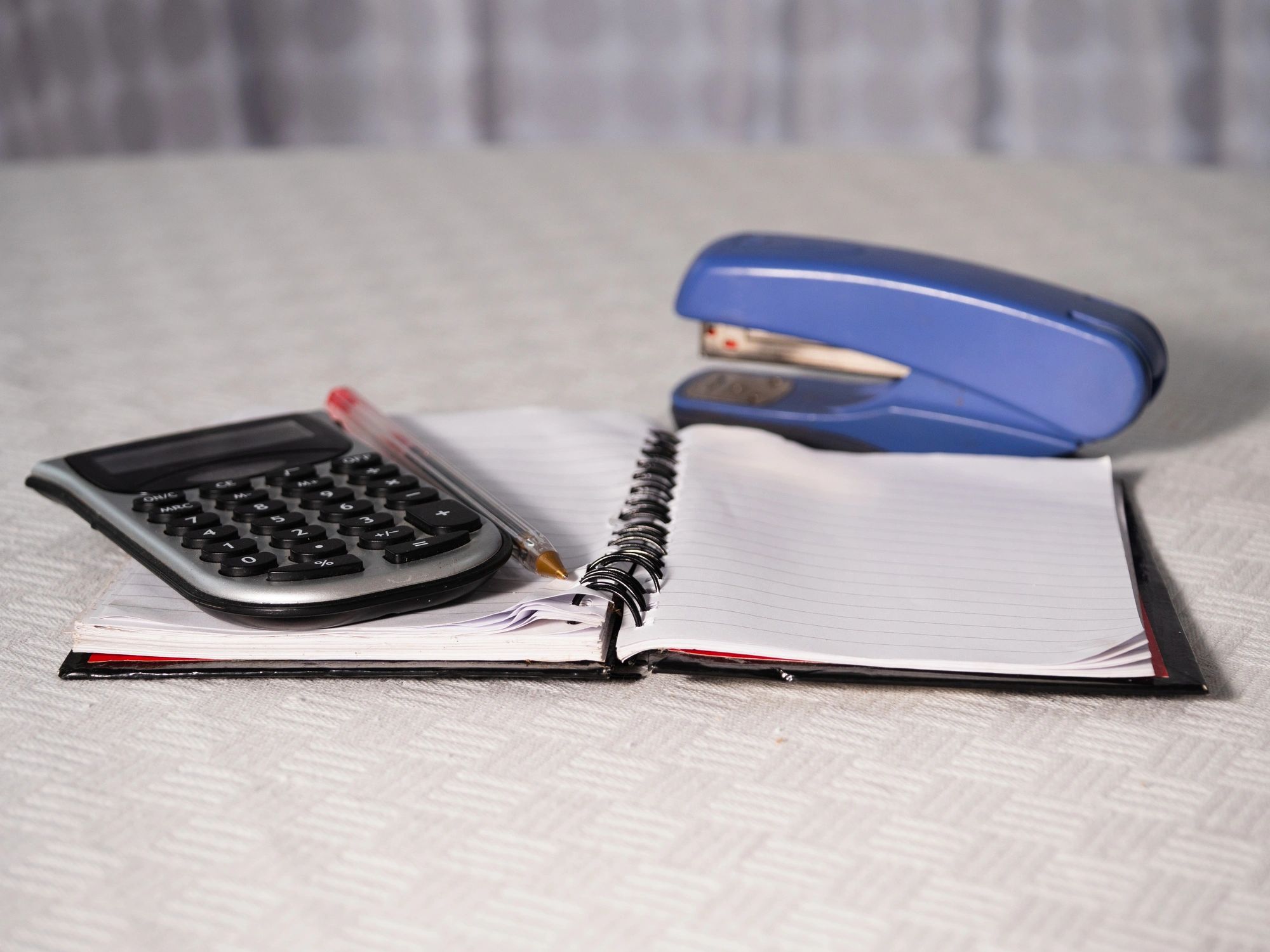 Calculator and notepad for construction project paperwork